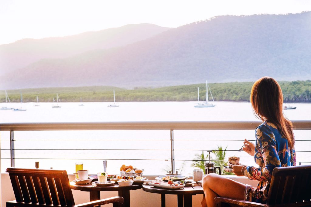 girl eating breakfast on balcony in Cairns